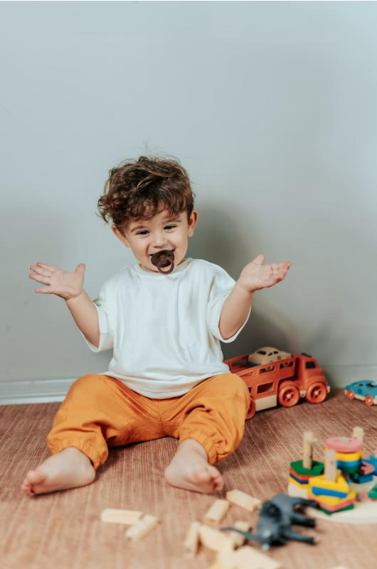 Happy child playing with educational toys at Kare